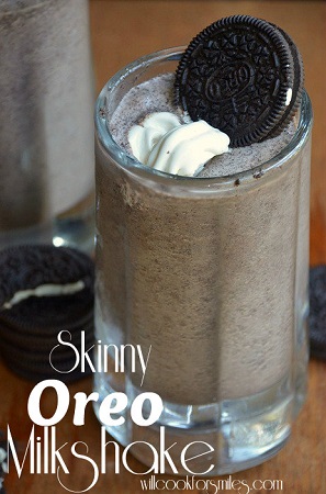 oreo milk shake in a glass mug with whipped cream and an oreo on top 