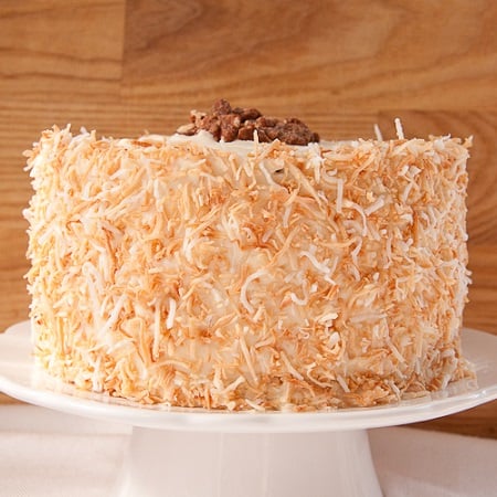 carrot cake on a white cake stand 