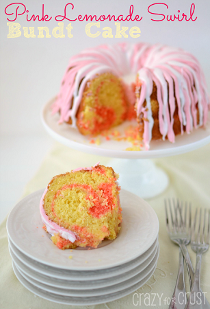 pink lemonade swirl bundt cake on a cake stand a slice cut out and put on a stack of white plates 