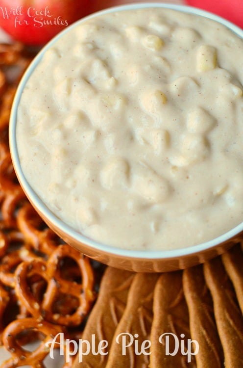 Apple Pie Dip in a bowl on a tray with cookies and pretzels on it 