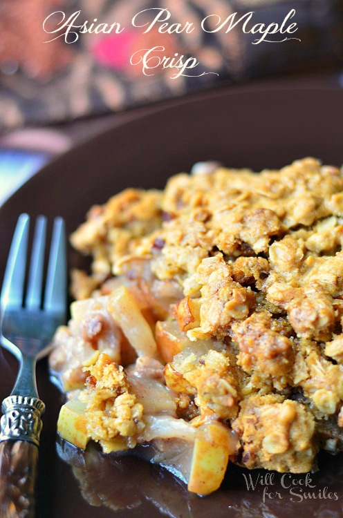 Asian Pear Crisp on a brown plate with a fork to the left 