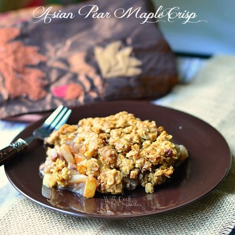 Asian Pear Crisp on a brown plate with a fork to the left 