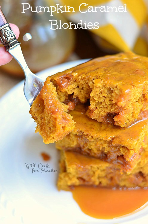 Pumpkin Caramel Blondies stacked on a plate with a fork scooping a bite 