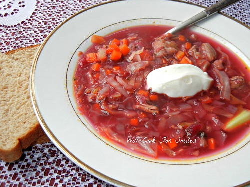 soup in a white bowl with a dollop of sour cream 