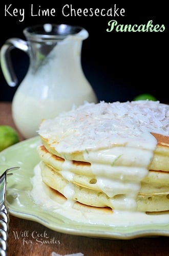 Key Lime Cheesecake Pancakes on a green plate with syrup in the background 