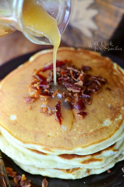 Maple Bacon Pancakes on a plate with syrup being poured over top