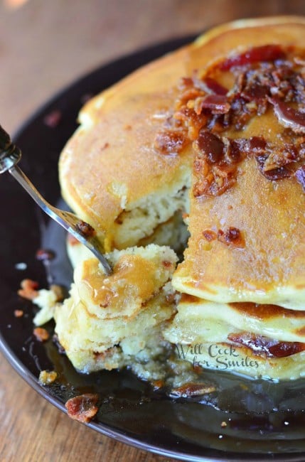 Bacon Pancakes on a plate with a fork with pancakes on it 