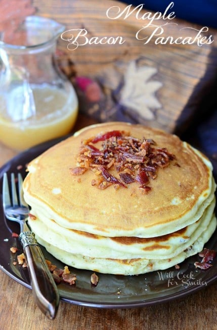 Maple Bacon Pancakes on a plate with a fork and syrup in the background