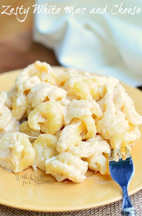 White Mac & Cheese on a yellow plate with a fork to the left 