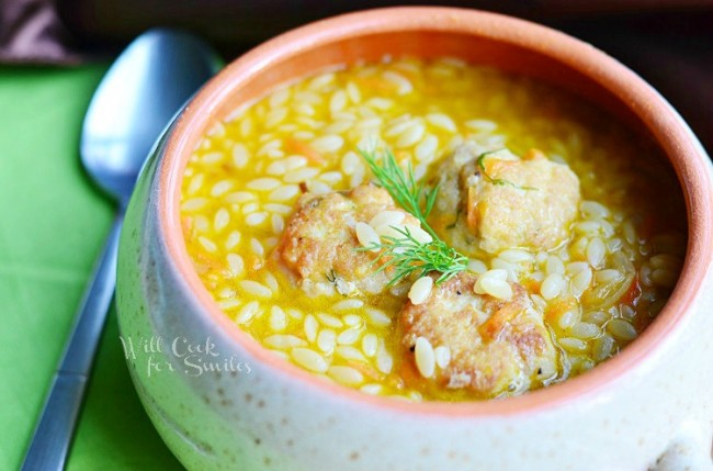 chicken meatball orzo soup in a bowl with a spoon 