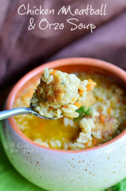 chicken orzo soup in a bowl and spoon with soup on it 