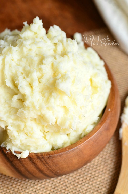 Perfect Mashed Potato Recipe in a wooden bowl on a brown place mat 