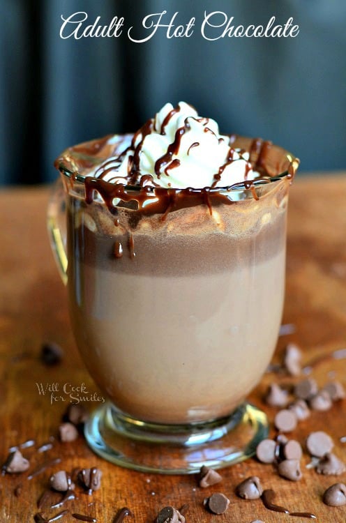 Adult Hot Chocolate in a glass up with whipped cream and chocolate sauce on top 