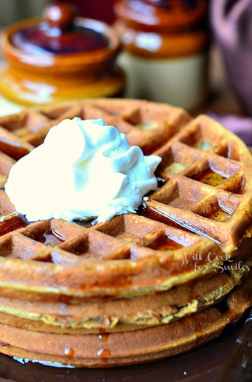 Gingerbread Waffles with syrup and whip cream on top 