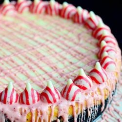 close up view of peppermint cheesecake with oreo cake crust on white table