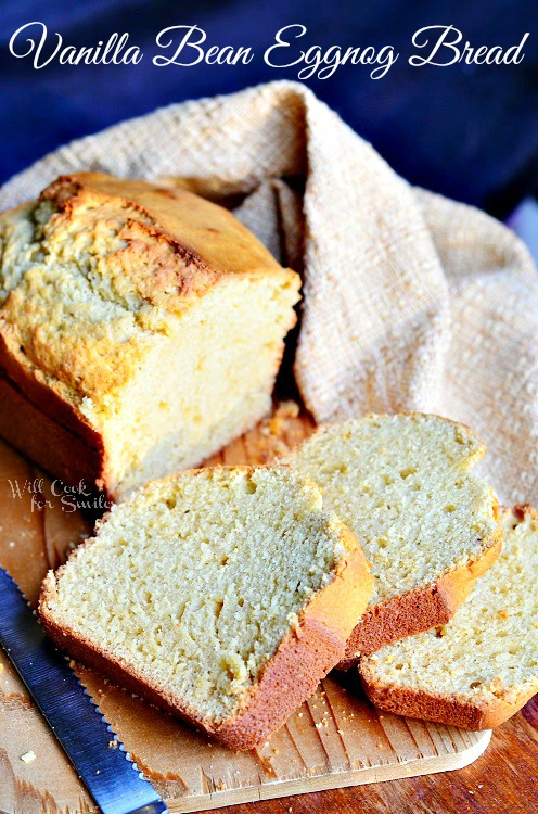 Vanilla Bean Eggnog Bread with slices on a wood cutting board 