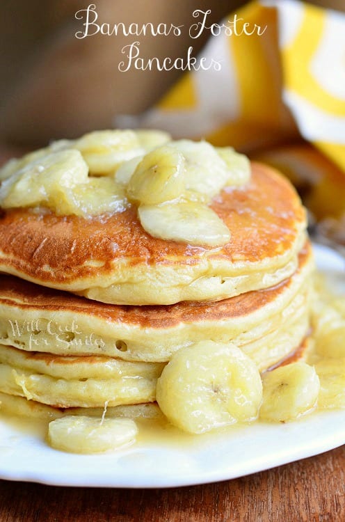 Bananas Foster Pancakes with sliced bananas on top on a white plate 