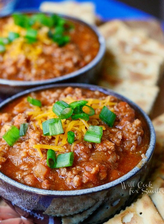 Chili Recipe with cheese on top in a blue bowl 