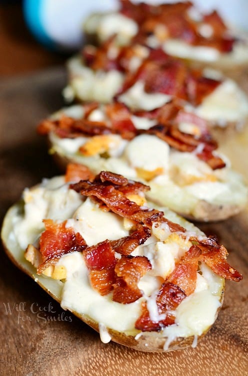 Chicken Bacon Ranch Loaded Potato Skins on a wood cutting board 