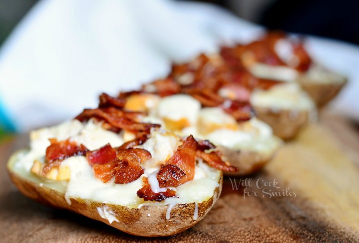 horizonal Chicken Bacon Ranch Loaded Potato Skins on a wood cutting board 