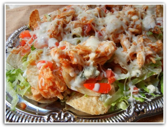 chicken nachos on a metal serving tray 