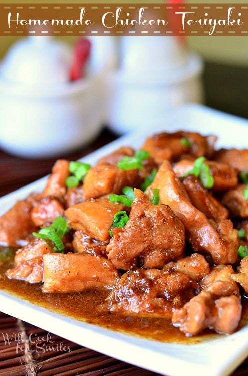 Chicken Teriyaki on a white plate with green onions sliced on top 