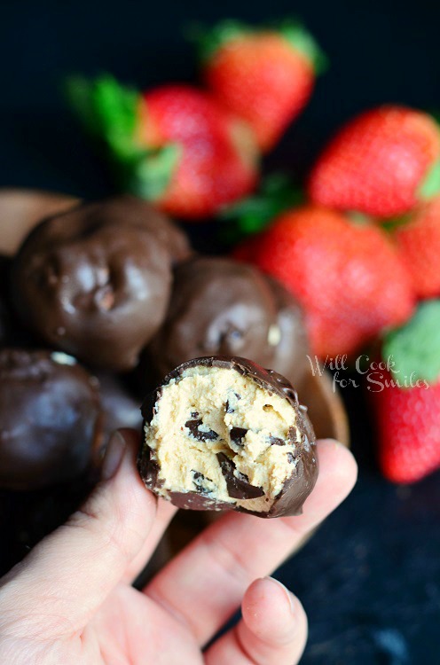 Chocolate Covered Peanut Butter Cheesecake Bites with a bite out of it 