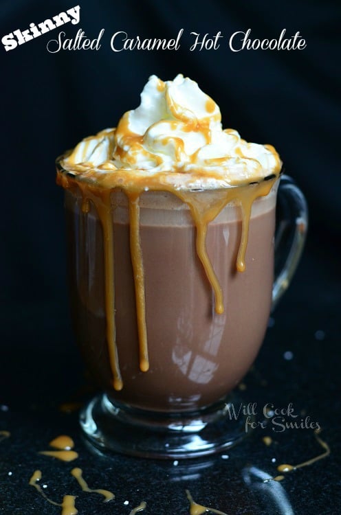 Caramel Hot Chocolate in a clear glass mug with whipped cream and caramel on top 