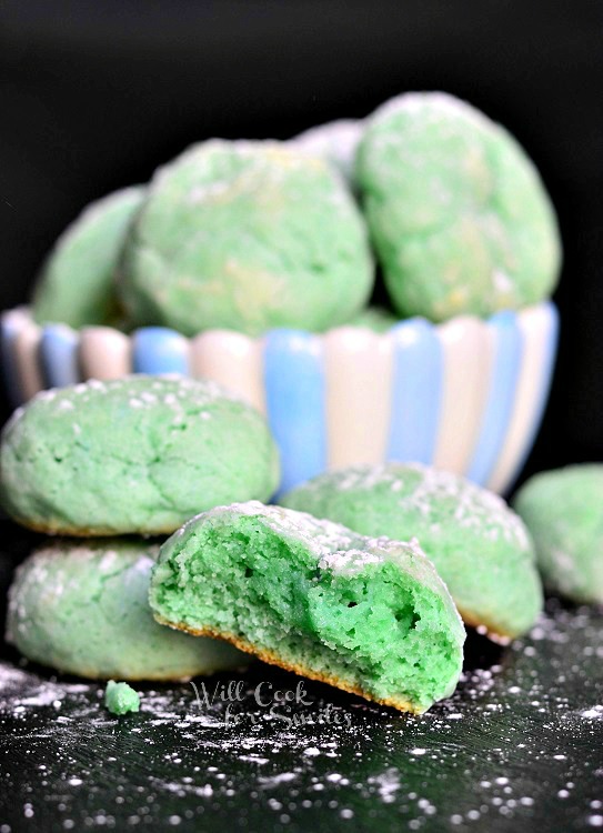 green Cotton Candy Cookies front one cut in half and some in the background in a blue and white stripped bowl 