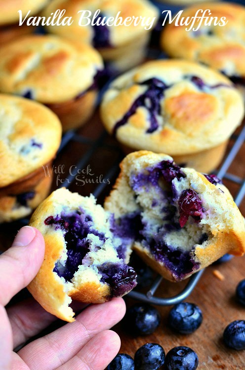 Vanilla Blueberry Muffins with one torn in half and I am holding a piece 