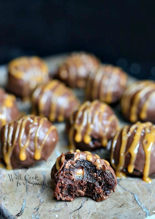 Salted Caramel Brownie Truffles with a bite out of own on a cutting board 