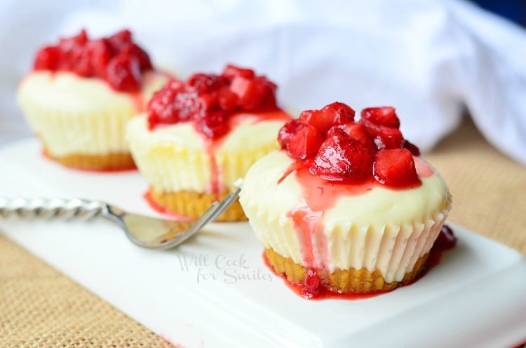 Mini Strawberry Cheesecakes on a white plate with a fork to the left