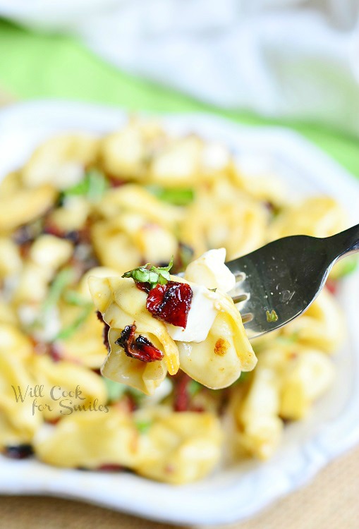 Caprese Tortellini Bowl  with a fork lifting out a bit 