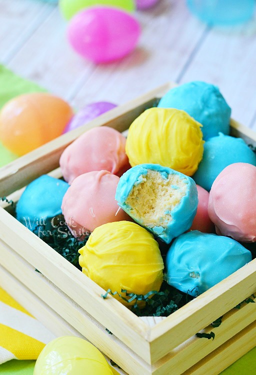 Easter Marshmallow Oreo Truffles in a wood box with a bite out of one 