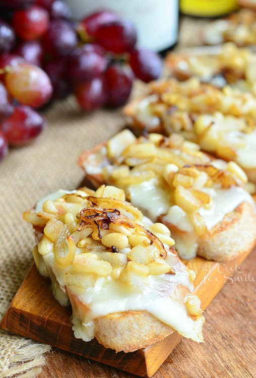 President's Cheese Crostini wtih Brie Caramelized Onion Pear and Pine Nuts on a tray 