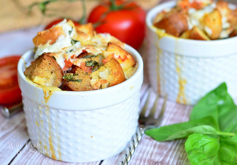 Tomato Basil Bread Pudding in a ramekin with basil to the right 
