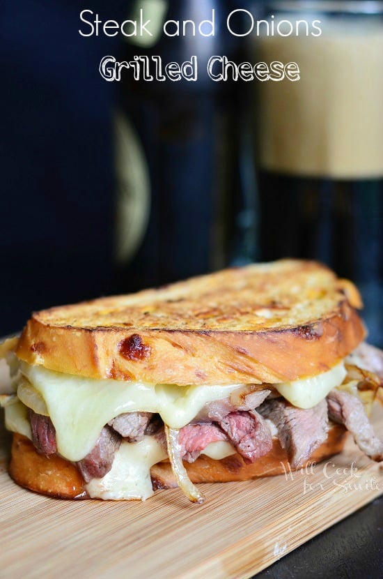 Steak and Onion Grilled Cheese on a wood cutting board 