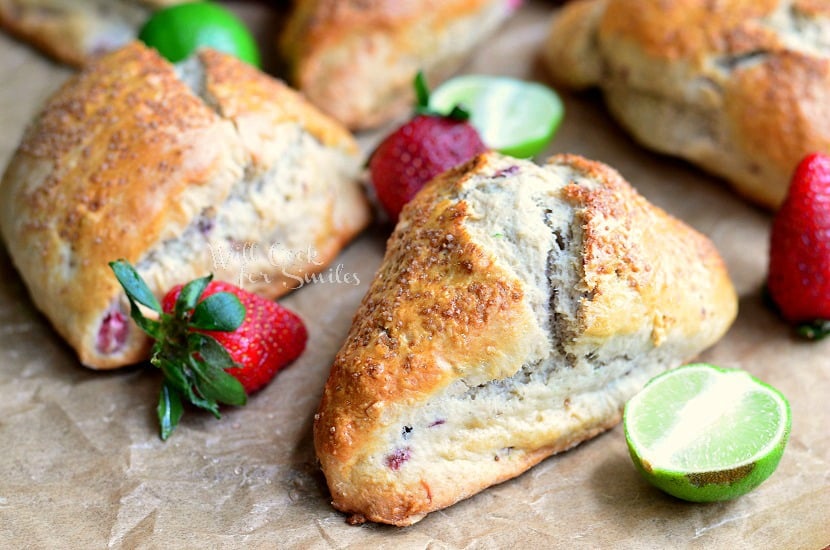 Strawberry Key Lime Scones on butcher paper with strawberry and limes 