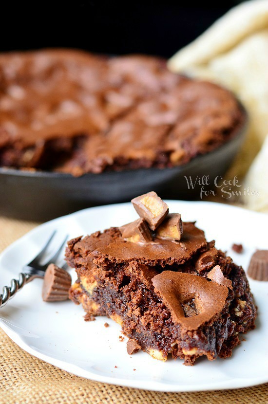 Peanut Butter Cup Skillet Brownies on a white plate with a fork to the left 