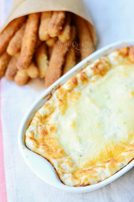 Cheesy Ranch Dip in a white casserole dish with chicken fries in the background 