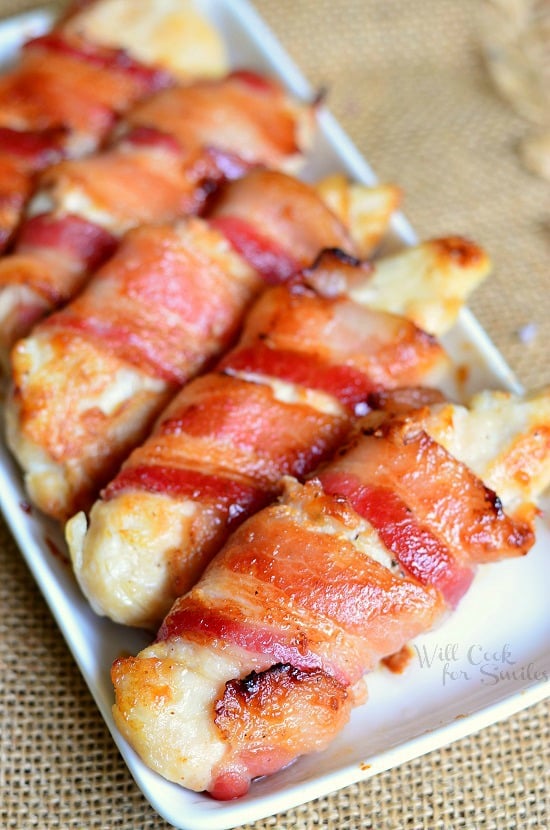 Bacon Wrapped Chicken Strips on a white serving plate 