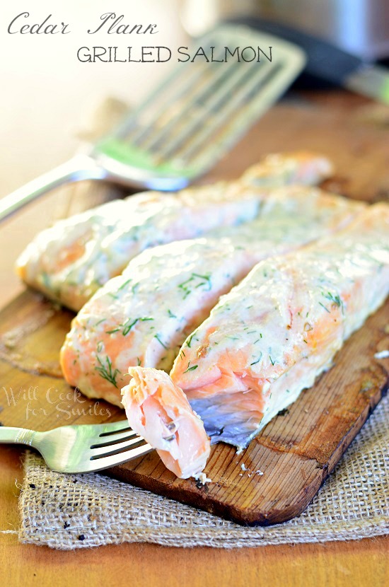 Amazing Cedar Plank Salmon smothered in creamy lemon dill sauce for you to grill this summer! | willcookforsmiles.com