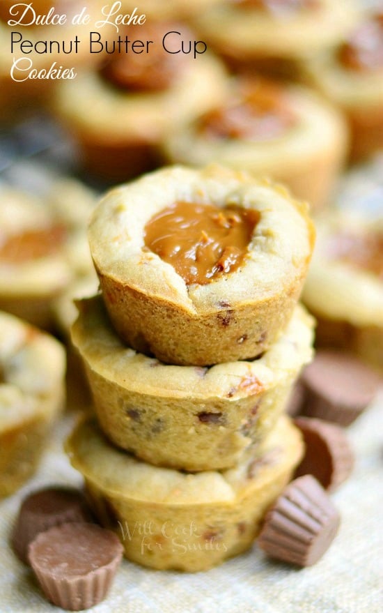 Dulce De Leche Peanut Butter Cup Cookies stacked ip with mini peanut butter cups around it 