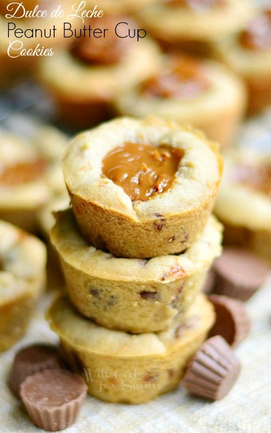 Dulce De Leche Peanut Butter Cup Cookies stacked up with mini reeses around it 