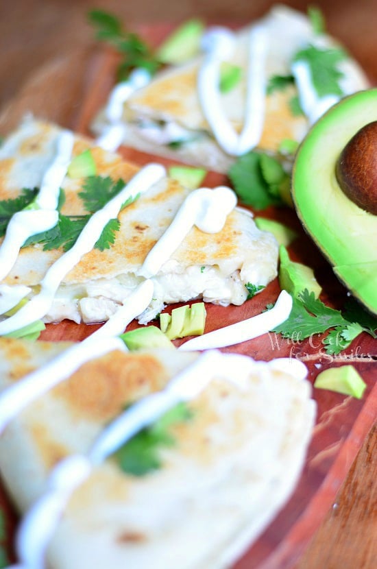 Avocado Chicken Quesadilla on a wood cutting board 