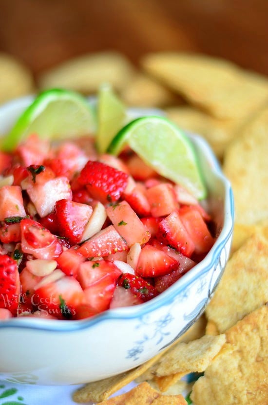 Dessert Strawberry Salsa in a bowl with chips around it 