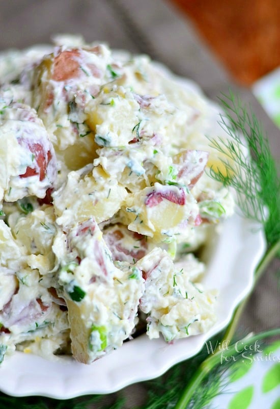 Parmesan Herb Potato Salad is served on a white plate.