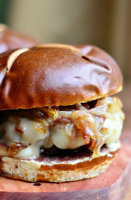 Buffalo Burger with Caramelized Onions and Demi Glace on a wood cutting board 