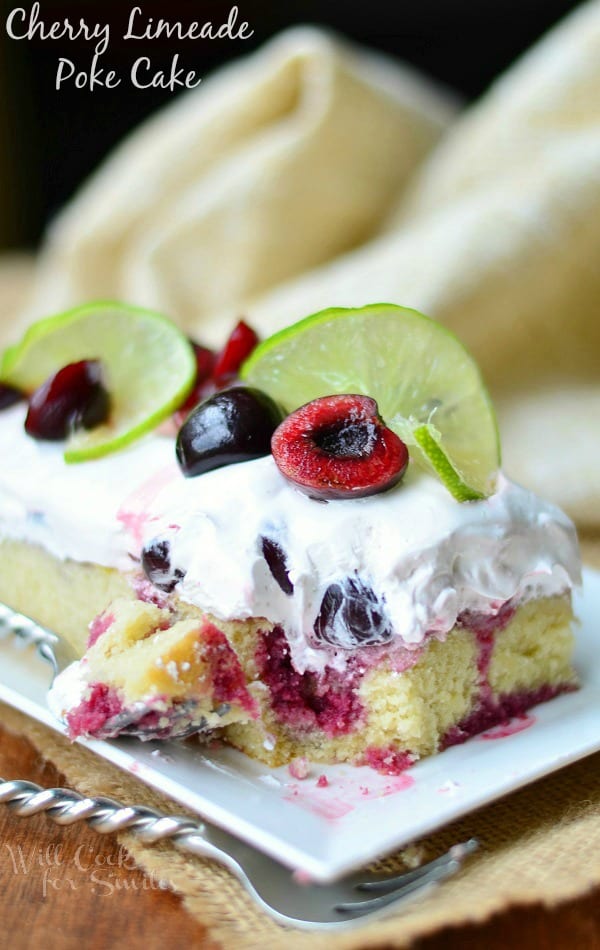 Cherry Limeade Poke Cake on a white plate with a fork 