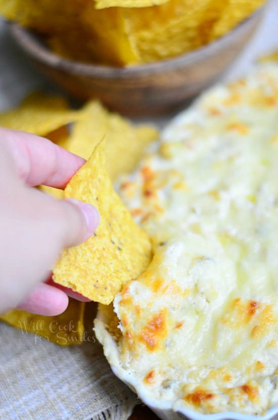 chip being dipped in Chicken Enchilada Verde Dip